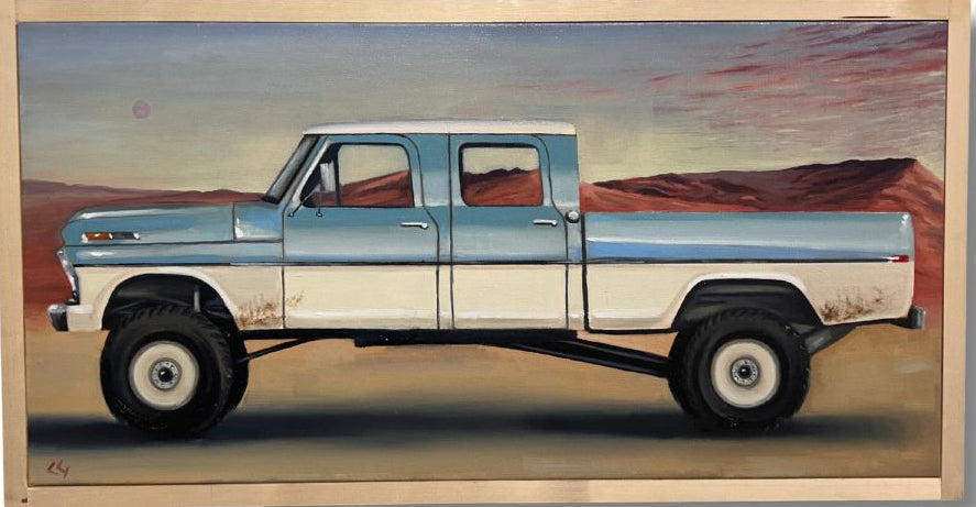 Framed artwork of a blue truck on a desert landscape