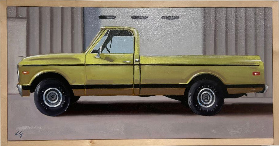 Framed artwork of a yellow truck on a white background